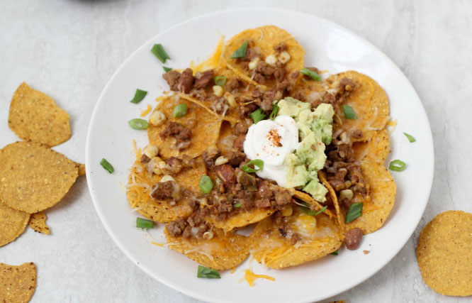 Looking for the perfect football-watching snack? These crowd-pleasing taco nachos are a little lighter than your typical party snack, but are still full of flavor and protein!