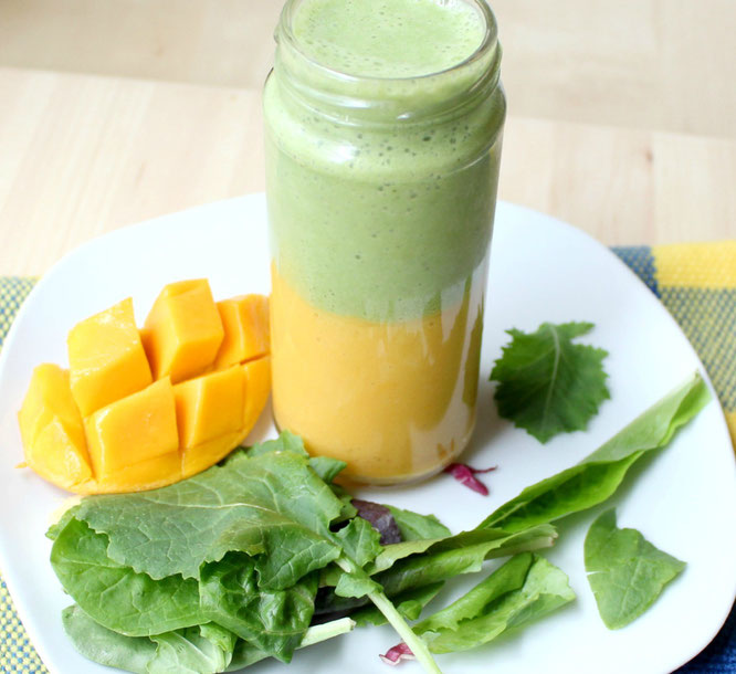 This layered smoothie has a sweet mango-banana base with an apple, greens, and tea smoothie on top.  It's a whole new world of flavor with two smoothies in one! - www.homemadenutrition.com