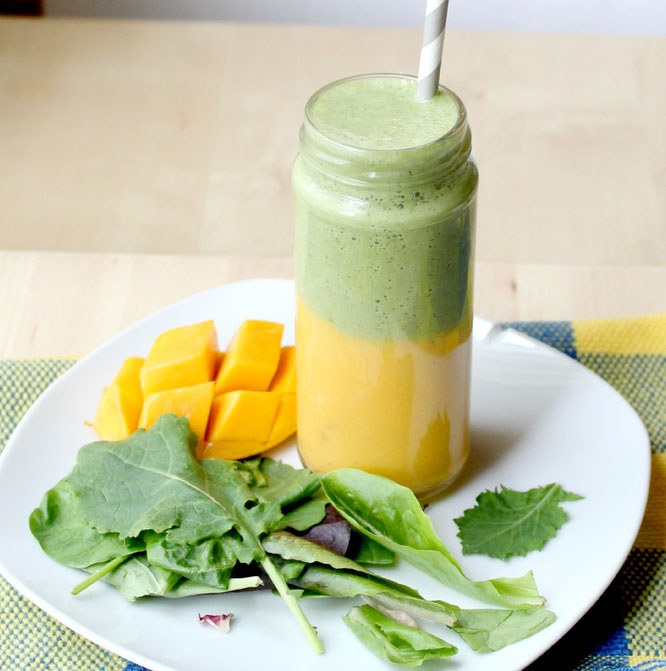 This layered smoothie has a sweet mango-banana base with an apple, greens, and tea smoothie on top.  It's a whole new world of flavor with two smoothies in one! - www.homemadenutrition.com