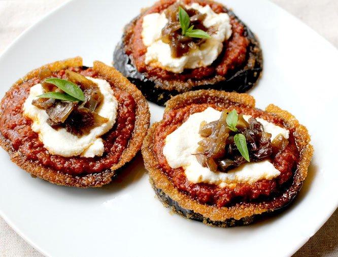 Baked eggplant makes the base of these flavorful pizzas topped with sun dried tomato pesto, ricotta, and caramilized onions. These are delicious and simple! - www.homemadenutrition.com