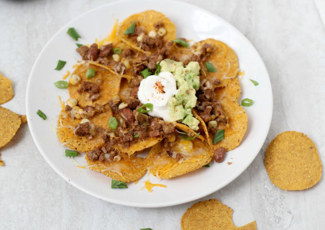 Looking for the perfect football-watching snack? These crowd-pleasing taco nachos are a little lighter than your typical party snack, but are still full of flavor and protein!