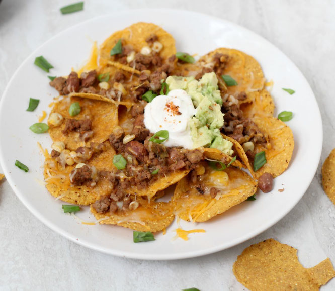 Looking for the perfect football-watching snack? These crowd-pleasing taco nachos are a little lighter than your typical party snack, but are still full of flavor and protein!