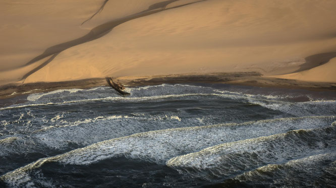 Bird`s eye view scenic flight shipwreck at the Atlantic Ocean and the Namib Desert Namibia