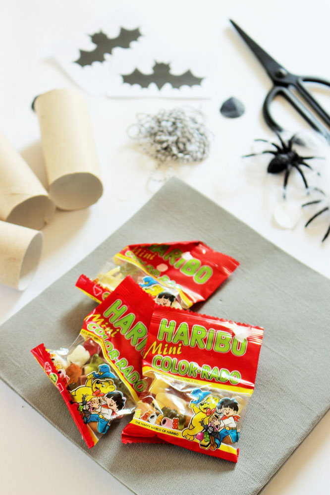 Bild: Eine schnelle last-minute Idee, um Halloween Süßigkeiten zu verpacken - als Knallbonbons mit Toilettenpapier-Rollen Upcycling und Servietten, inkl. Fledermaus Bastelvorlage; noch mehr DIY Ideen für Halloween gibt's auf www.partystories.de