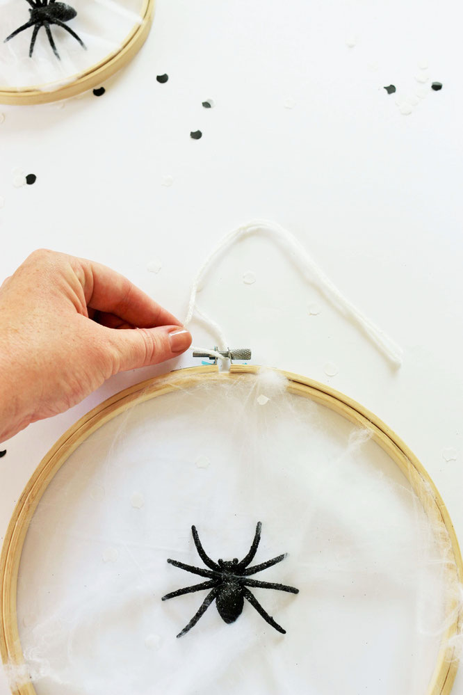 Bild: DIY Halloween Deko Idee – mit dieser Anleitung einfach ein Spinnennetz als Halloween Party Deko aus Stickrahmen und Watter selber machen, gefunden auf dem DIY Deko und Partystyling Blog www.partystories.de // #Halloween #Halloweendeko #diyHalloween
