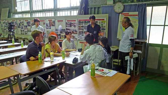 Students from Ikuno High School learning about the ecology and the conservation issues surrounding the local giant salamander populations at the Hanzaki Institute (Mr. Tochimoto on right)