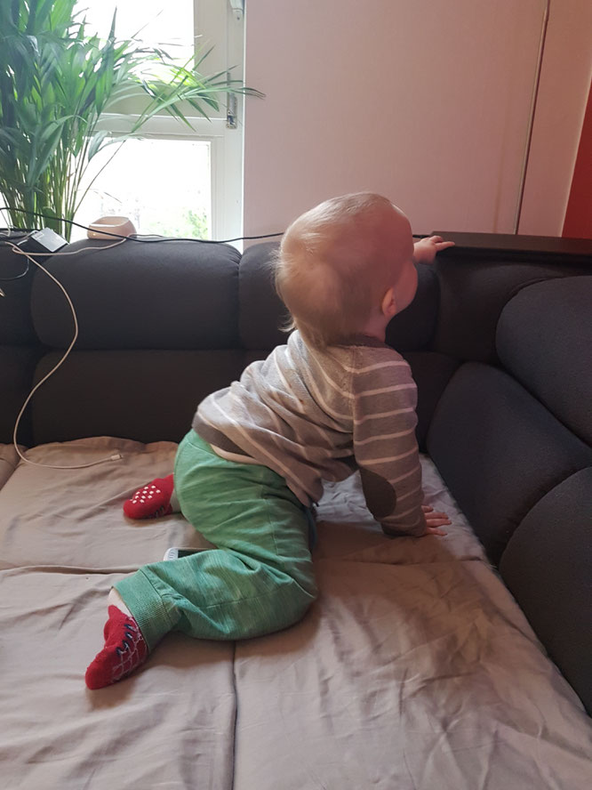 Kleinkind, 15 Monate alt, spielt gern mit Laptop, Telefon und Kabeln.