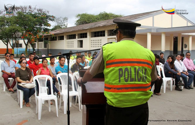 Un oficial de policía instruye sobre seguridad a un grupo de jóvenes cursillistas. Manta, Ecuador.