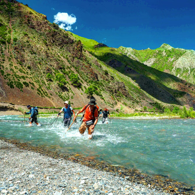 trekking in Kyrgyzstan. Crossing mountain river 