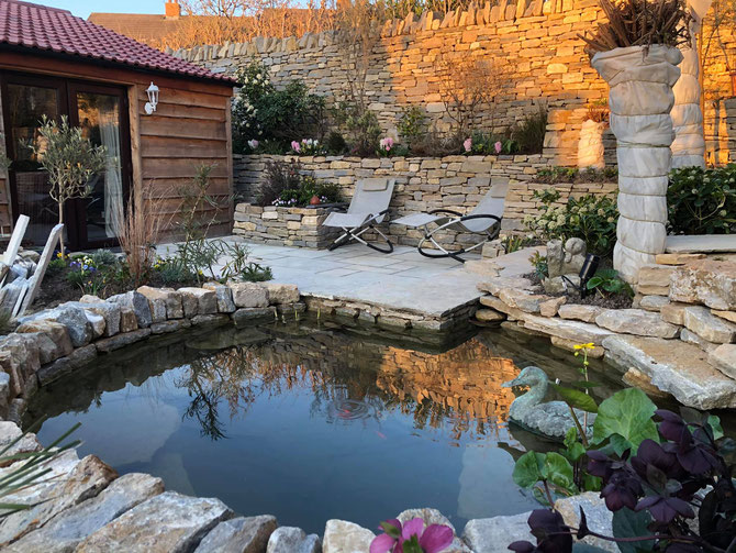 The stone creating space, and privacy, with pond as the central feature