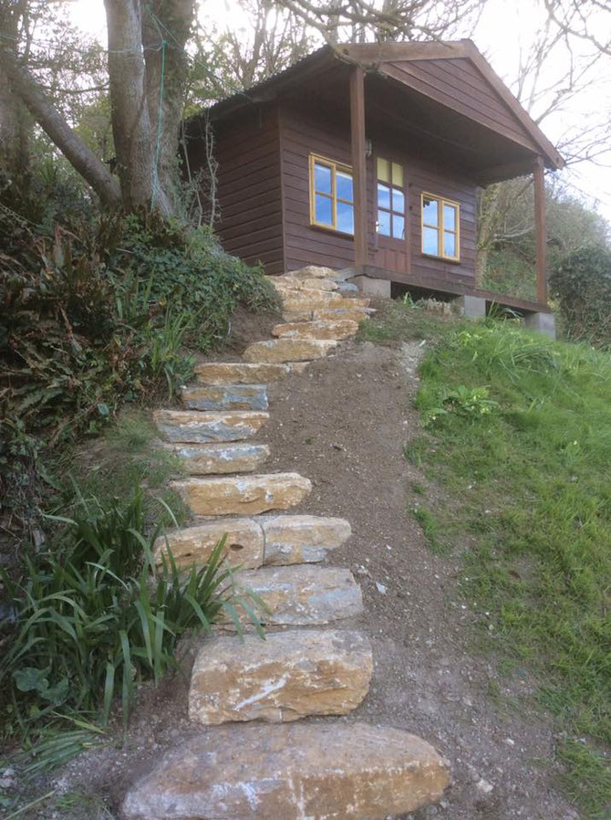 Stone steps leading to wooden shed
