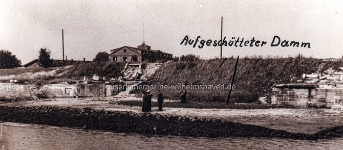 Privatfoto mit Blick auf den Damm in Richtung Jadebusen. In der Bildmitte das 1915 errichtete Netzsperrgebäude