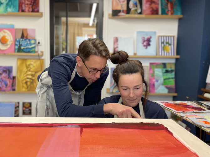 Koppel overlegd over de details van een persoonlijk schilderij dat ze maken tijdens een privé workshop schilderen in Breda