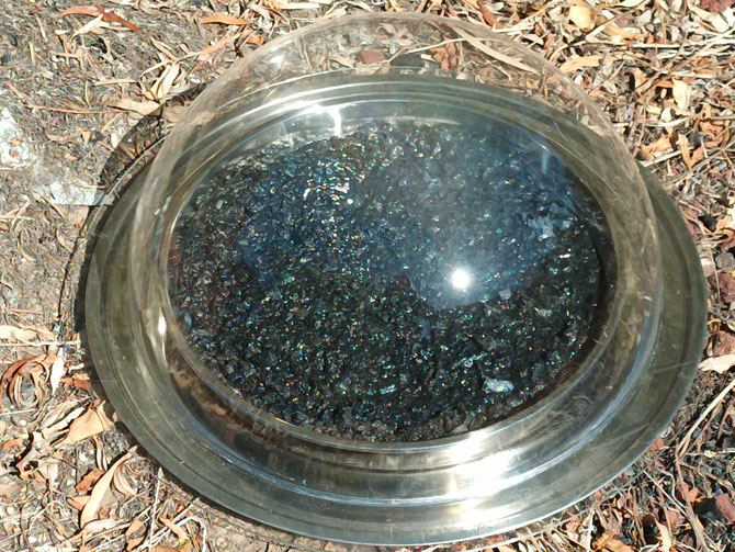 An adapted AWH mainframe sitting on a 100L stainless stockpot lid, with 40cm wide 304 baking tray with biochar (and some water for initial testing) and a 450mm acrylic dome on top for condensation and collection