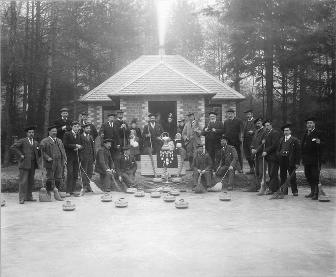 Errol curling club, new bothy and pond, 1901-02.  Standing, from right: Scot Symon (3rd), Scot's uncle James Symon (6th) (possibly), Scot's father Peter Symon (7th) and Errol Estate factor and club secretary David Hardie (8th).