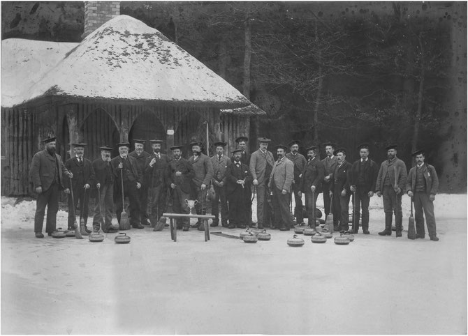 Errol and Murie curling club, at clubhouse and pond in Lornie wood, circa 1890s.  Peter Symon, 4th from left.  Peter's son, James "Scot" Symon, 5th from right.  Possibly Peter's brother, Jame Symon, 5th from left. 