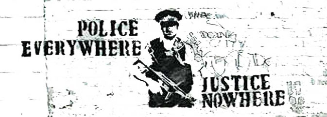 street graffiti saying 'Police everywhere, justice nowhere'.