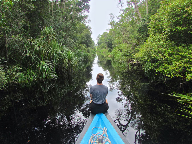 riding down a river in Borneo