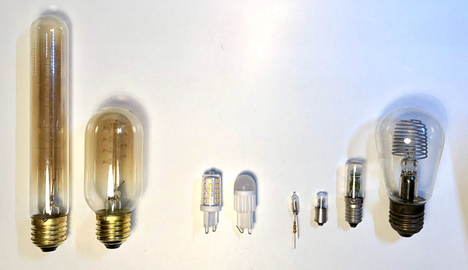 The picture shows 3 types of light bulbs: Edison incandescent bulbs, LED spot bulbs and neon glow bulbs