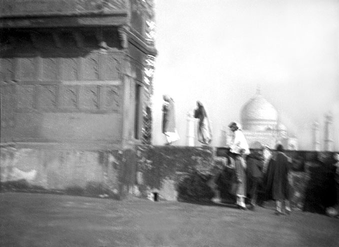 MSI Collection ; 1937 - Baba and party tour the Red Fort in Agra, the Taj Mahal in the distance.