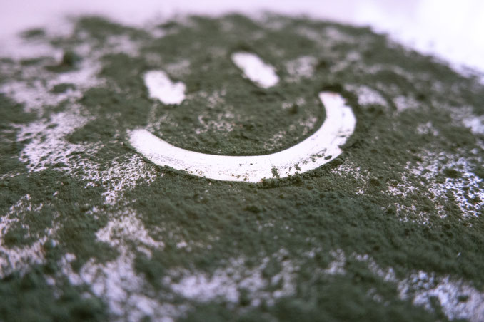 Marine Phytoplankton Pulver in Nahaufnahme mit Smiley-Motiv – gesundes Superfood für Wohlbefinden und Vitalität