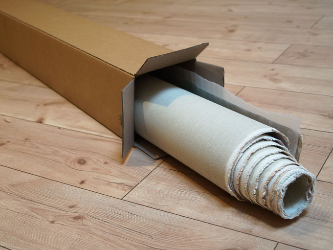 rolled canvas in a cardboard box