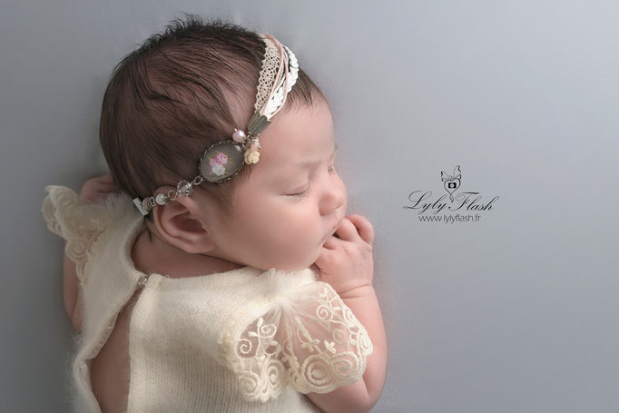 portrait photo de naissance d'un nouveau-né d'art . Une photographie avec un bijoux de naissance photographe original en studio photo