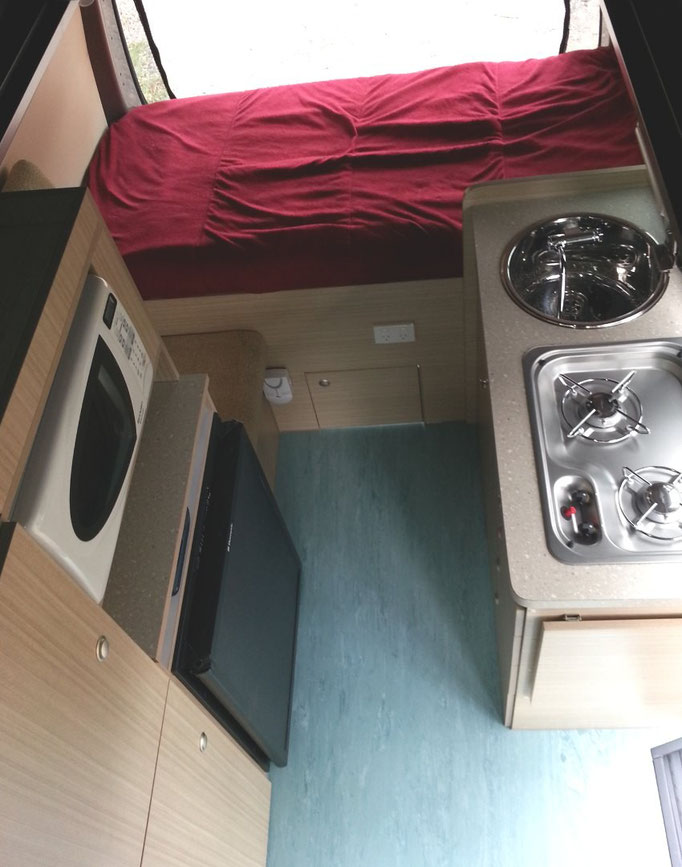 kitchen area on passenger side and bed to sleep across