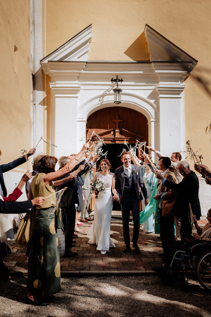 Hochzeitsfotograf am Schliersee. Das Brautpaar wird von den Hochzeitsgästen gefeiert und das Brautpaar freut sich.