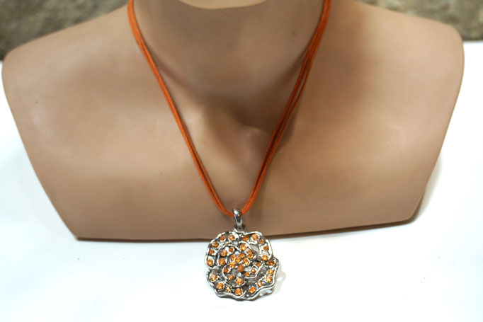 Collier aus 3 orangen Schnüren mit Metallblüte, die mit orangefarbigen Steinen verziert ist. Neuwertiger Zustand. Preis: 3,00 €
