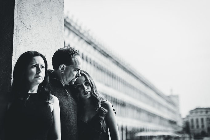 Documentary-style photo of Family in side canal at sunset in Venice