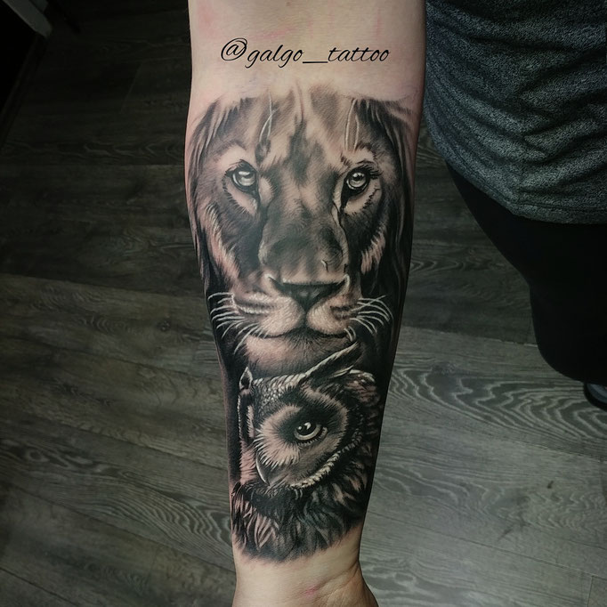 Realistic forearm tattoo of a lion and an owl.