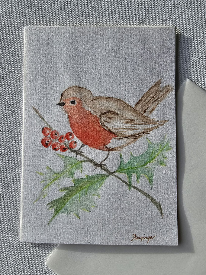 Aquarell Weihnachtskarte gemalt Rotkehlchen auf Ilex und "Frohe Weihnachten"-Handlettering auf der Innenseite