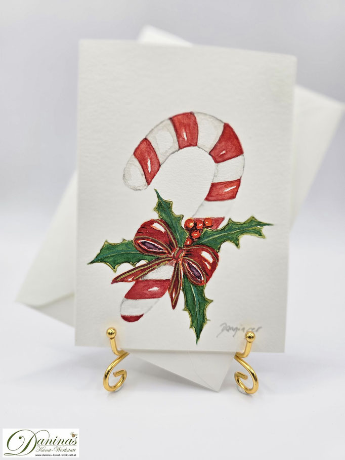 Außergewöhnliche Weihnachtskarte Aquarell Zuckerstange mit Ilex und Schleife