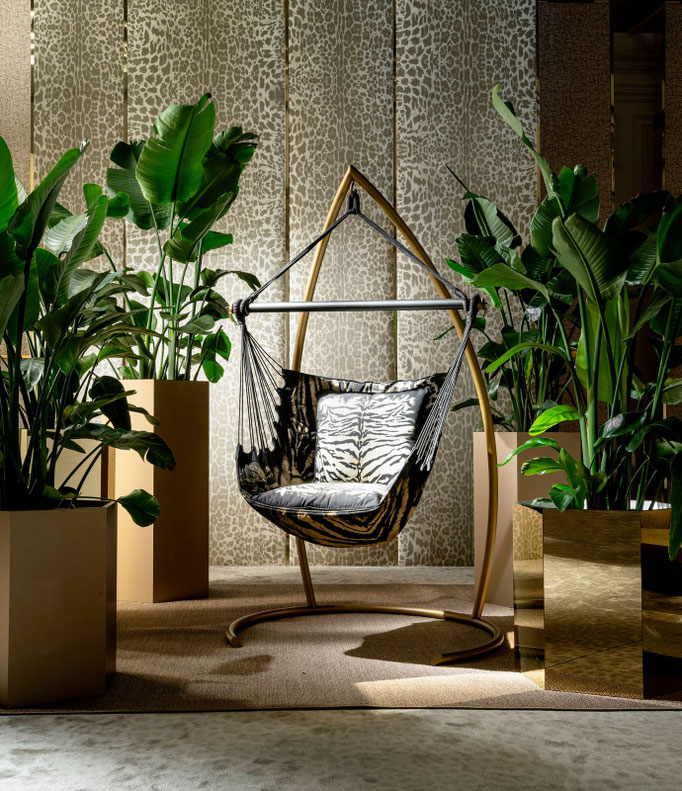 Wild hammock chair designed by Luca Tornaghi for Roberto Cavalli Home, suspended lounge chair with curved metal frame and animalier upholstered sling seat