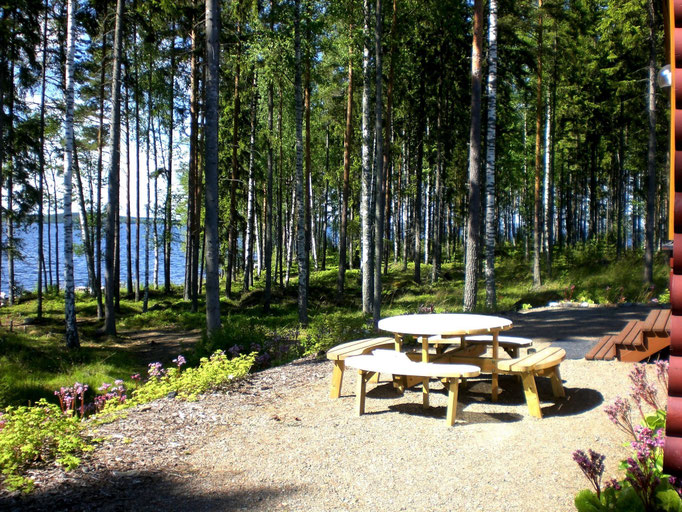 Eine der Außensitzgruppen Südseite vor dem Haus mit Wellenrauschen und Blick auf den See. Blick Richtung Südwesten zur benachbarten Halbinsel