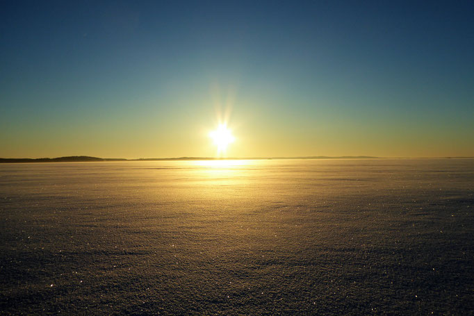 Sunset near the house at frozen Lake Päijänne