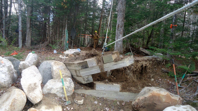 The bridge abutment is dismantled using the skyline