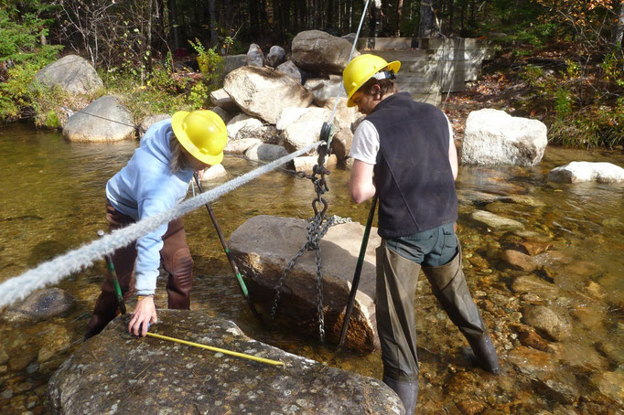 Dan measures the gap as Chris puts holds the stone