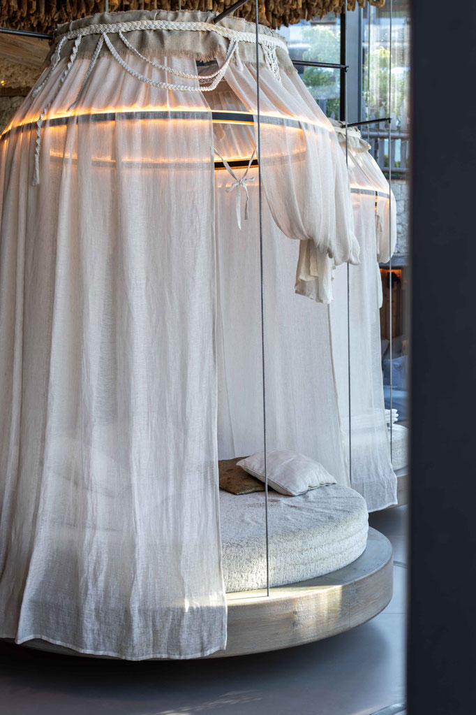 Rundes Himmelbett mit leichten Vorhängen im Pure Organic Spa von DER ENGEL im Tannheimertal. Die geschützte Ruheoase mit sanfter Beleuchtung lädt zum Entspannen und Abschalten in exklusivem Ambiente ein.