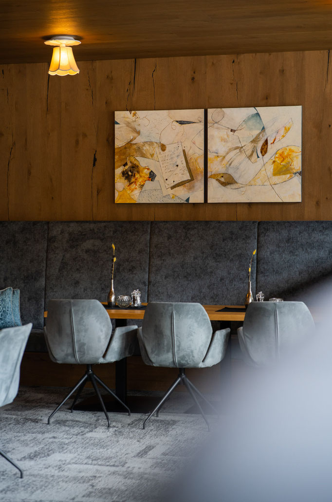 An elegant restaurant area with modern seating at the Hochkönigin Wellness Hotel in Maria Alm, Salzburg