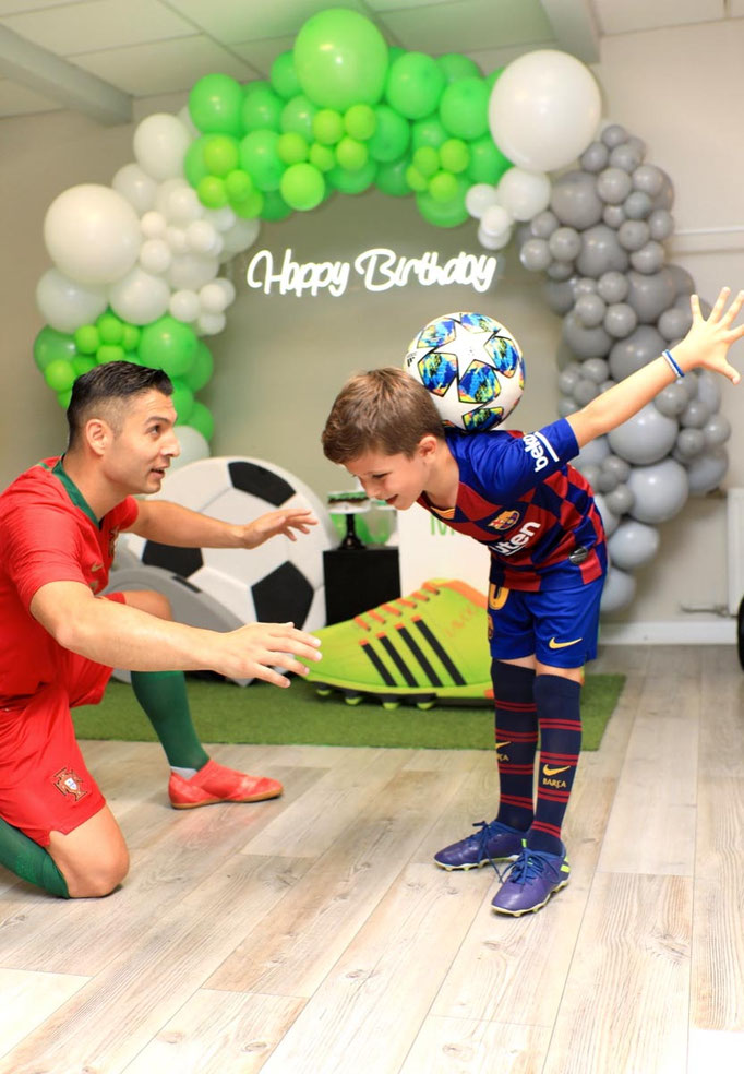 Kind lernt den Fußball-Nackentrick beim Workshop mit Freestyler Saki.