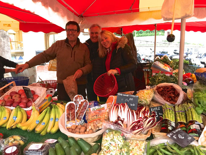Romano, Zsolt and Eva in their fruits and vegetables stand at La Condamine market, Monaco