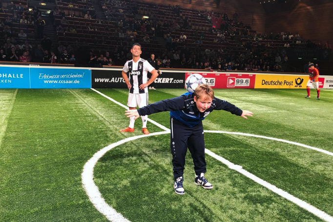 Nachwuchskicker präsentiert Fußball-Tricks vor großem Publikum in der Fußball-Arena.