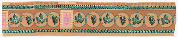 decorative boarder of antique wallpaper with green grapevine motif on orange background