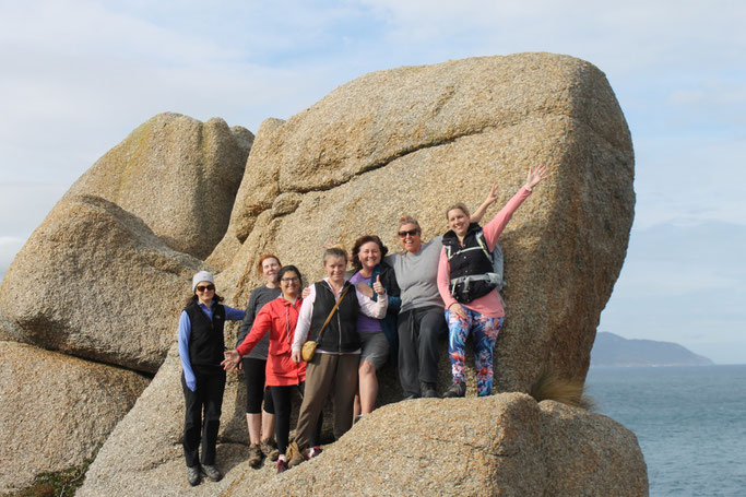 A group of happy ladies climbed a rock at Wilsons Prom National Park, Gippsland, Australia