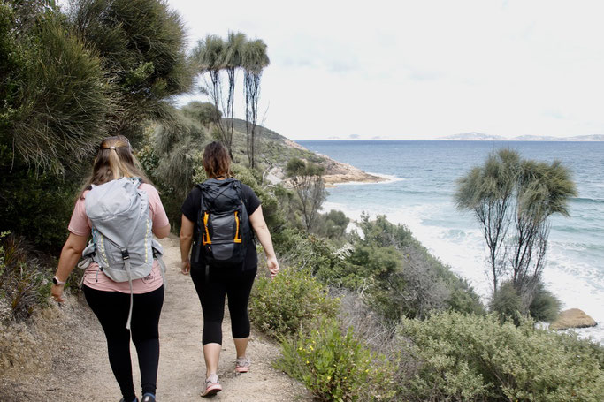 Two ladies hiking past ocean views at Wilsons Prom National Park