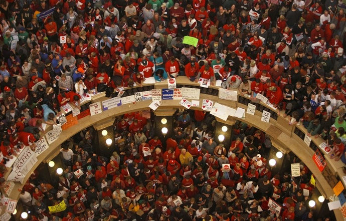 Andy Manis / AP Protestors of Wisconsin Gov. Scott Walker's bill to eliminate collective bargaining rights for many state workers pack the rotunda at the State Capitol in Madison, Wis. on Feb. 17, 2011.