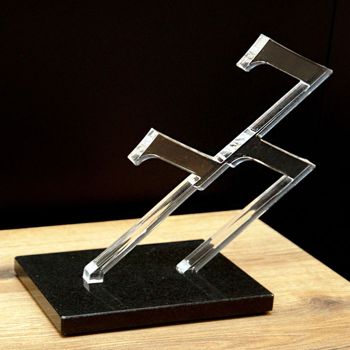 Paolo Grassi plexiglass sculpture 777 on black base, symbolic numeric artwork on table