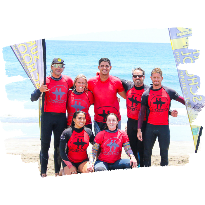 Surf Canaries instructor team group photo on the beach at Playa del Inglés, Gran Canaria